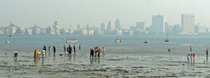 Mumbai skyline and people on the beach