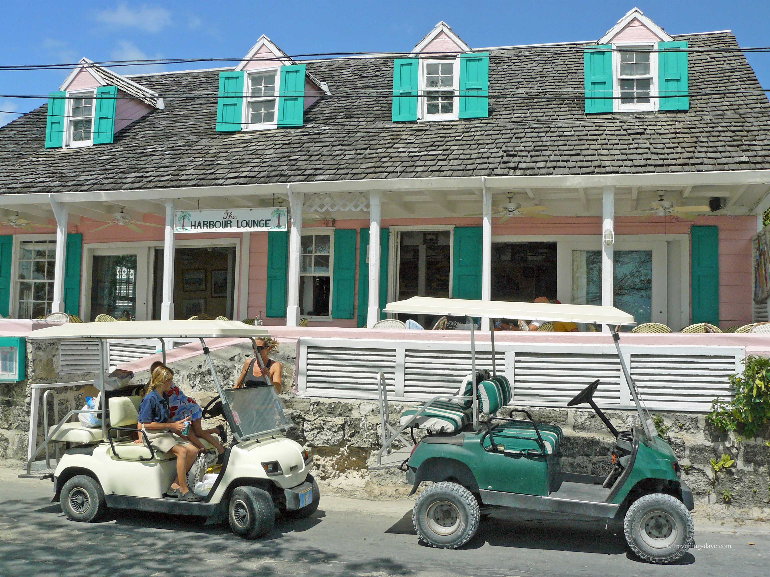 Golf buggies parked outside a restaurant on Harbour Island