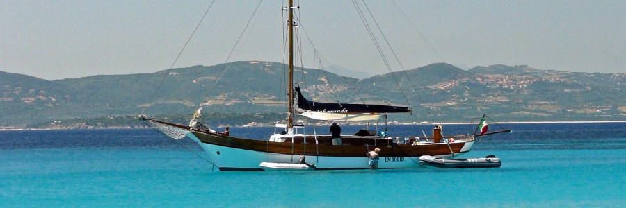 A boat and a dingy on the water