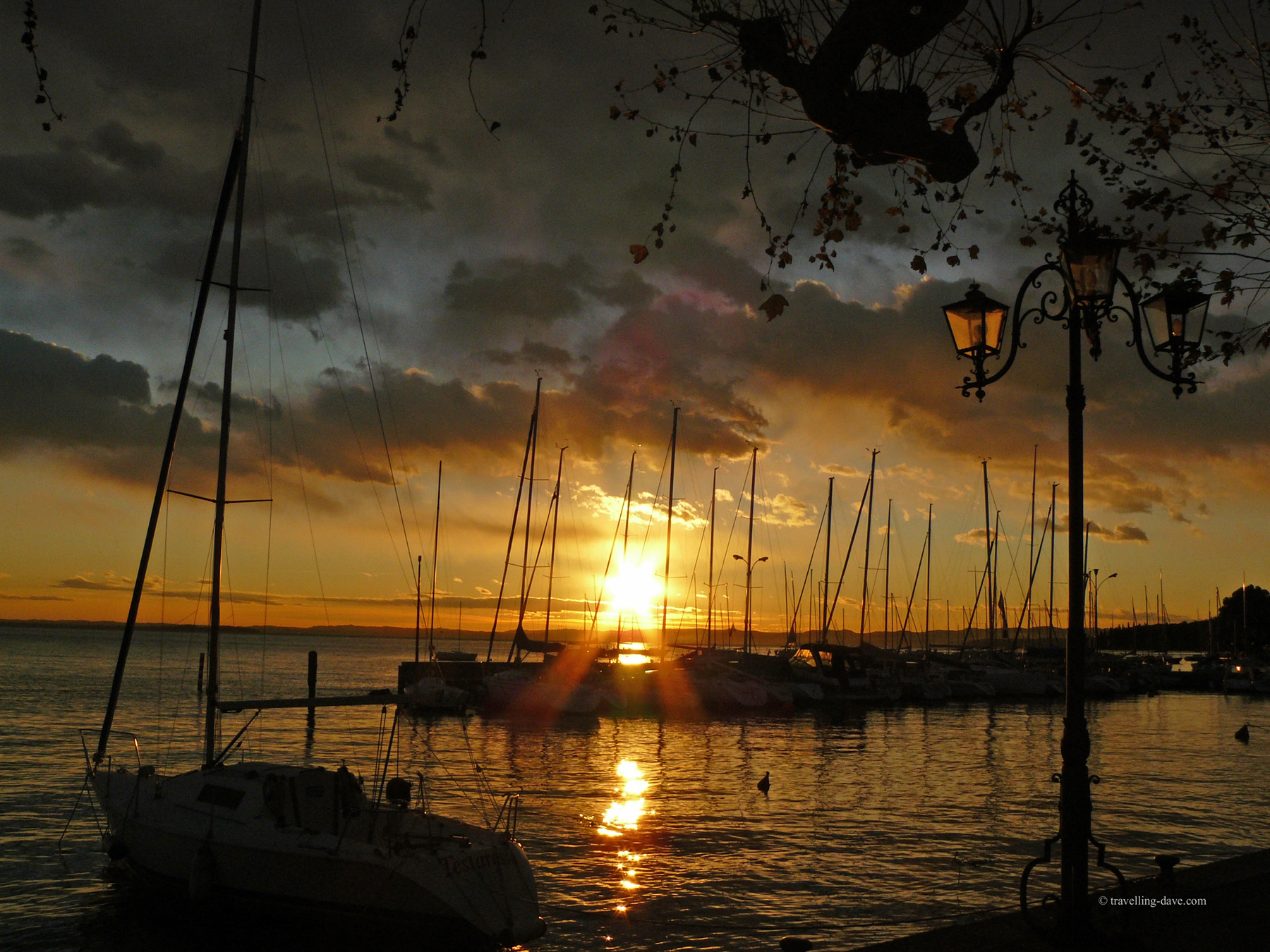 Sun setting on Garda's harbour in Italy