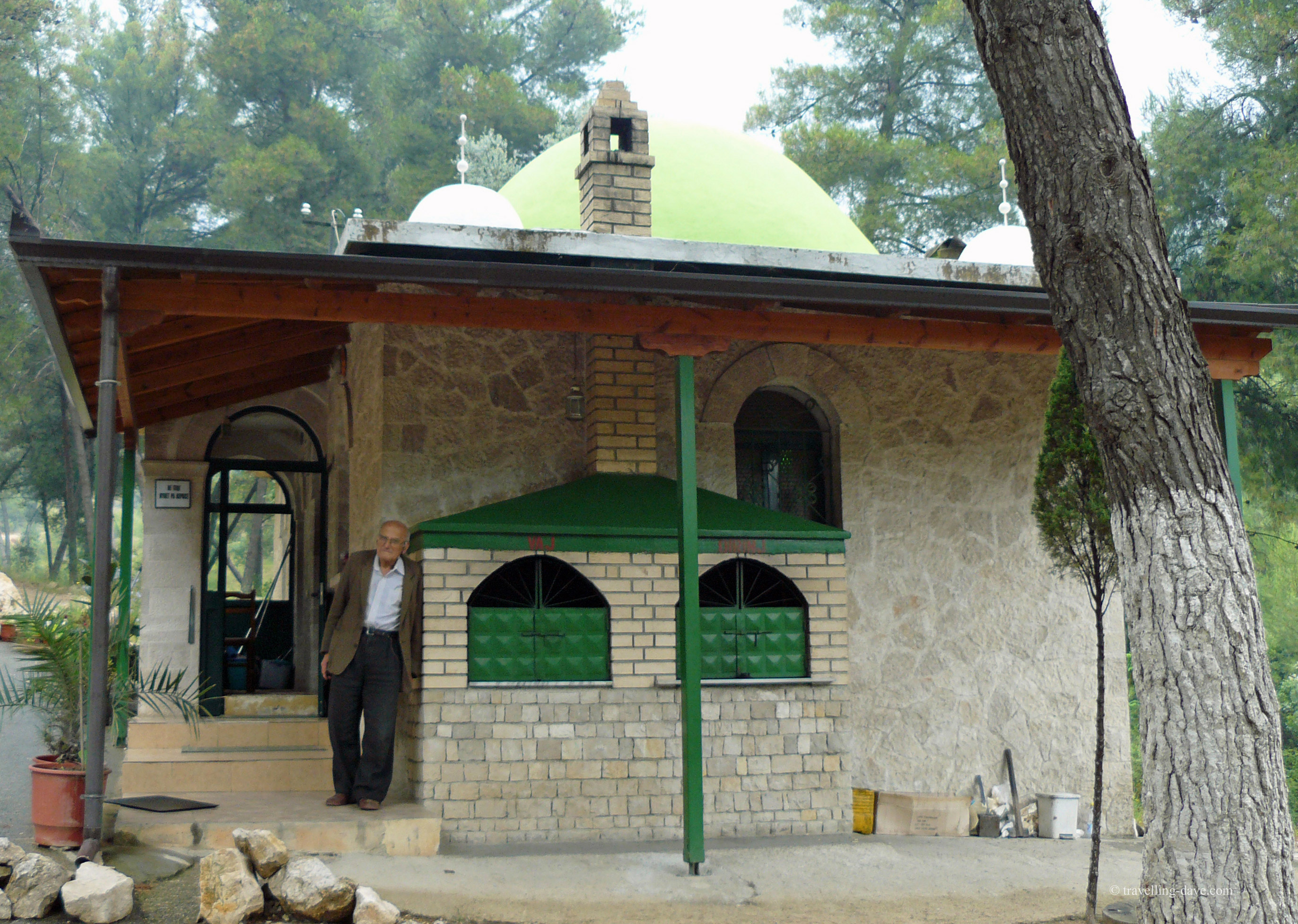 Man standing outside Sari Sartik Shrine in Albania
