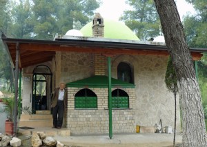 Man standing outside Sari Sartik Shrine in Albania