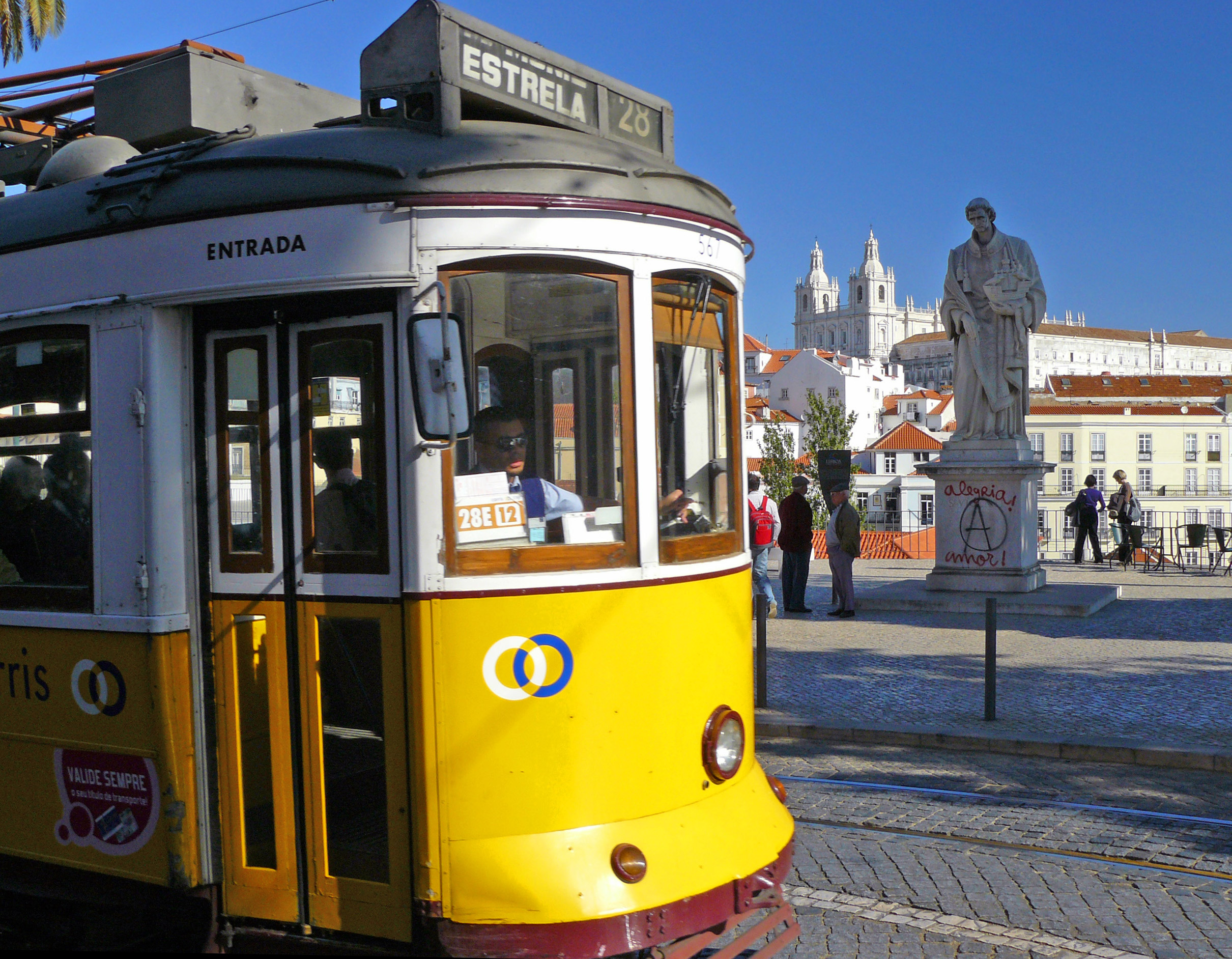 Statue and yellow tram in Lisbon