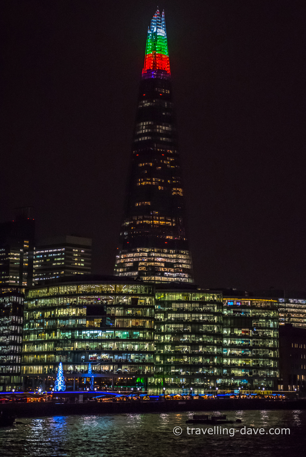 White red and green lights on the top of the Shard