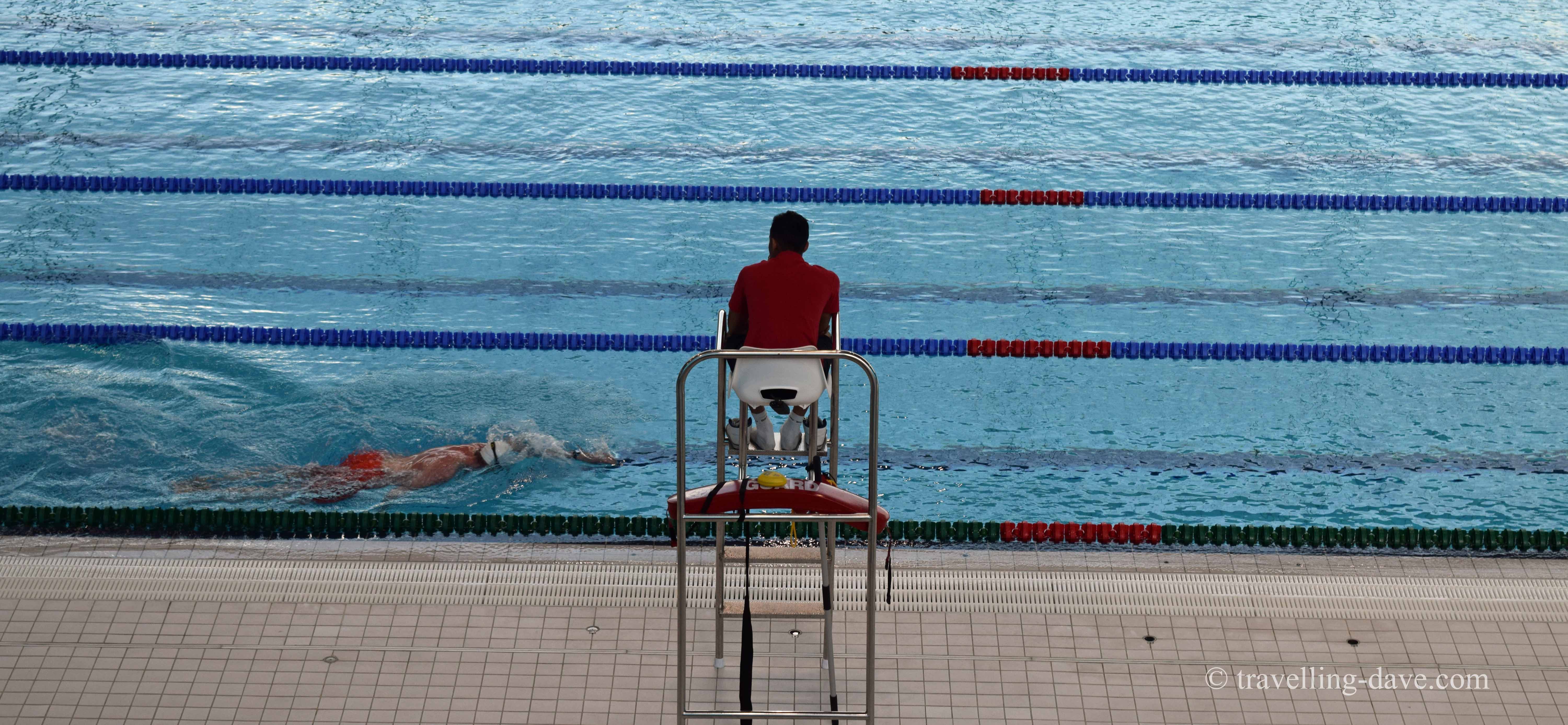 View of the pool and a lifeguard at London Aquatics Center