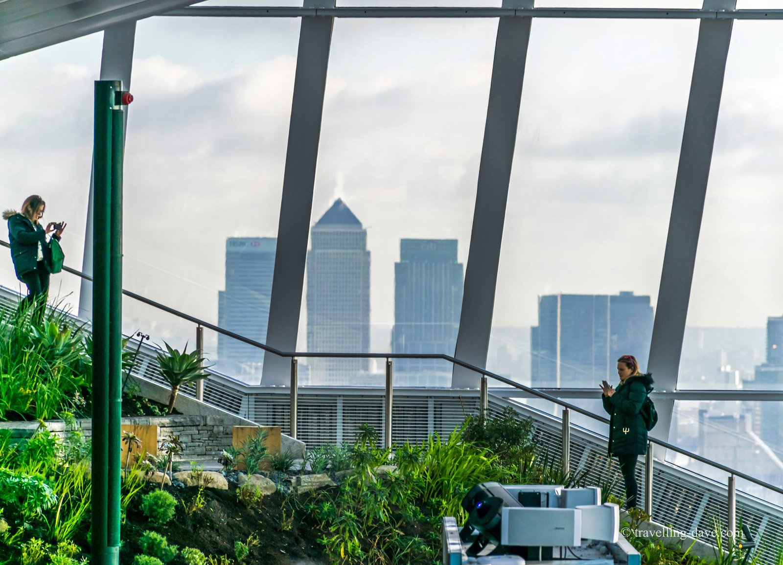 People on the steps by the window on the Sky Garden