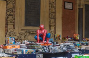 A Spider-Man figurine on top of books