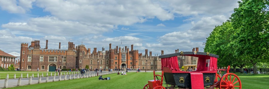 View of a red carriage and Hampton Court Palace