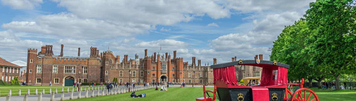 View of a red carriage and Hampton Court Palace