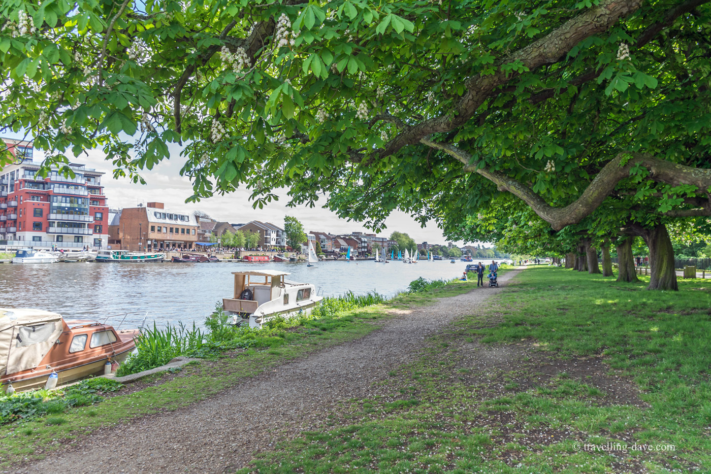 People and boats on the riverside