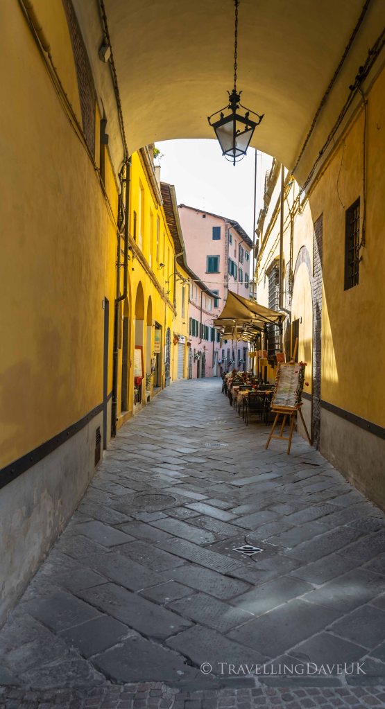 View of a colourful narrow street in Lucca in Italy