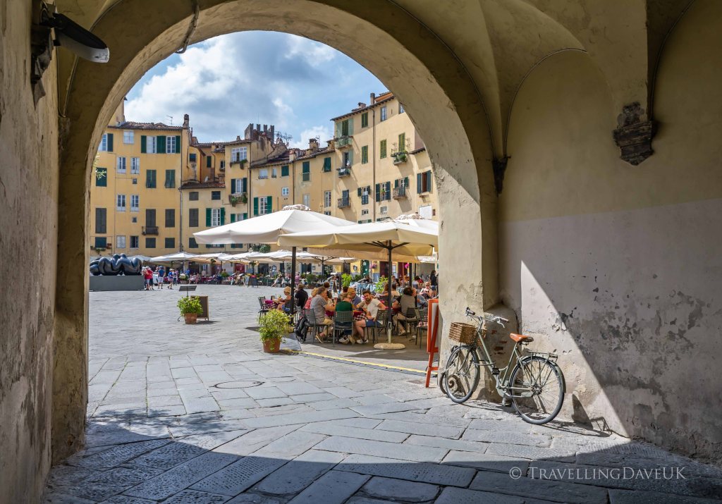 View of one of the archway entrances to Piazza Anfiteatro in Lucca in Italy