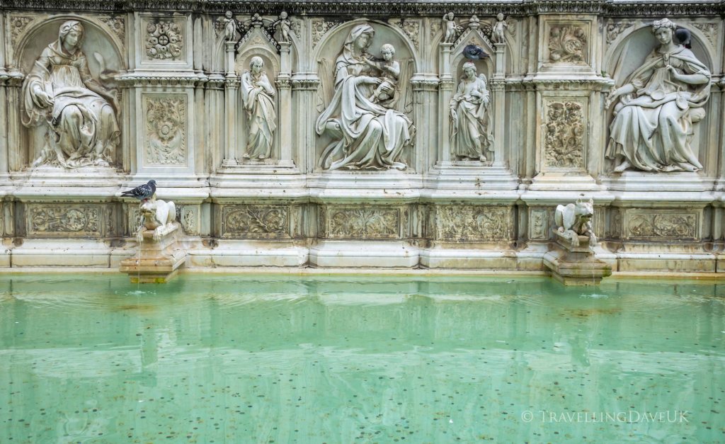 View of sculptures on the Fonte Gaia in the town of Siena in Italy