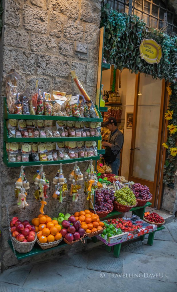 View of a colourful display outside a fruit and veg shop in Siena in Italy